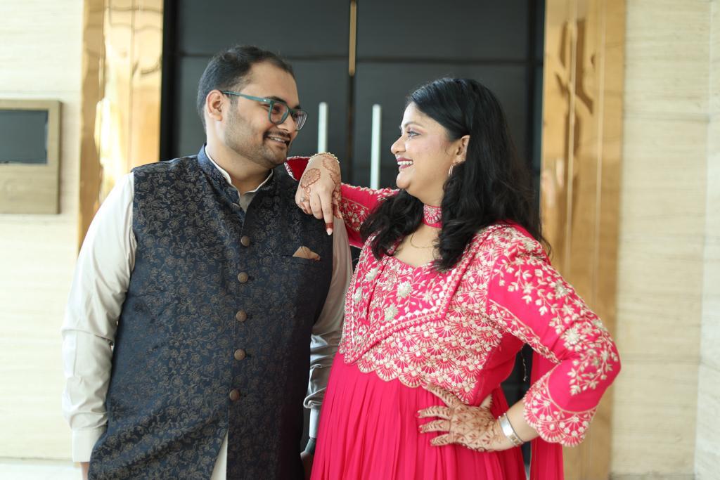 Salil and Eesha laughing together in traditional clothes